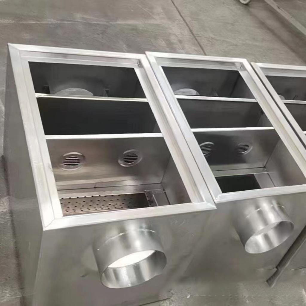 Kỹ thuật viên đang thực hiện lắp đặt một bể tách mỡ inox dưới chậu rửa trong căn hộ chung cư.